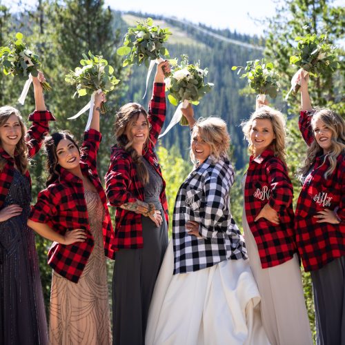 Bridal party in flannel shirts over their dresses